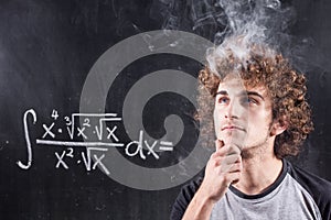 Thinking boy solving equation with smoking head