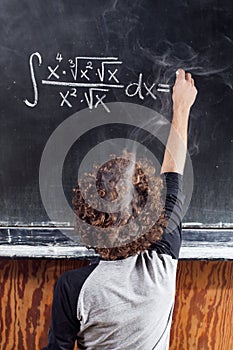 Thinking boy solving equation with smoking head photo