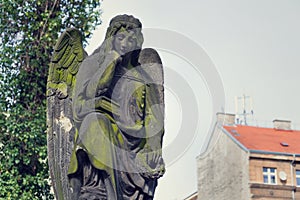 Thinking broody angel statue on Malostransky cemetery, Prague, Czech Republic