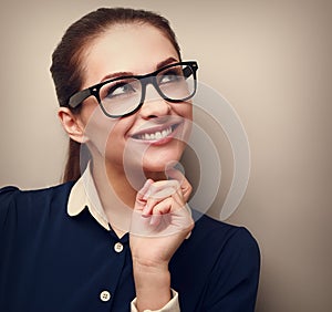 Thinking business woman looking up with hand at face