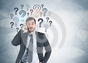 Thinking businessman with many questions