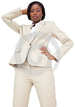Thinking businesswoman in cream suit