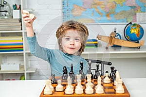Thinking child. Little boy playing chess. Concentrated boy developing chess strategy, playing board game.