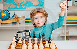 Thinking child. Little boy playing chess. Concentrated boy developing chess strategy, playing board game.
