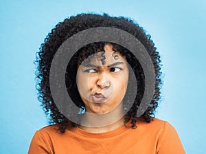 Thinking, confused and black woman in studio for emoji, contemplating and thought on blue background. Girl, doubt and