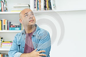 Thinking and dreaming bald mature adult man