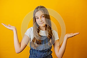 Thinking face, thoughtful emotions of teenager girl. Thoughtful teenage child girl on blue  background. Portrait of a kid