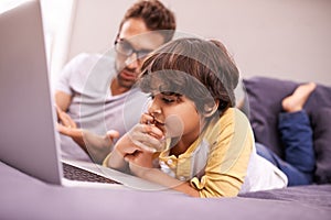 Thinking, father and child with computer for learning in bedroom with connectivity, technology at home. Family, man and