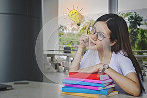 Thinking idea student girl with glasses and books on desk, Bored