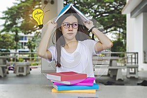 Thinking idea student girl with glasses and books on desk, Bored