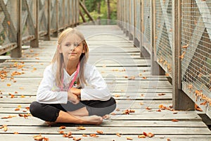 Thinking little girl on bridge