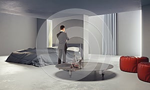 Thinking man in concrete bedroom
