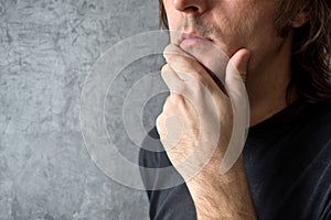 Thinking man with hand on his chin