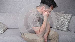 thinking man on sofa at home