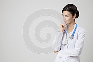 Thinking medical doctor woman with stethoscope.