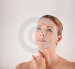 Thinking, mockup or mature woman with beauty or ideas in studio isolated on white background. Facial treatment, skincare