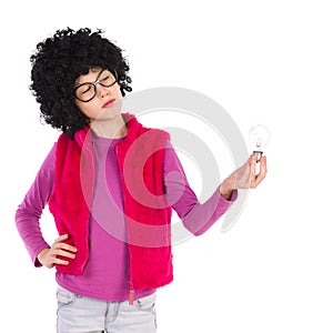 Thinking nerdy girl holding a light bulb