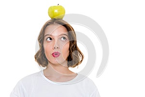 Thinking pretty caucasian woman holding apple on head