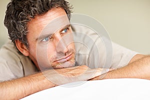 Thinking, relax and mature man in bed in the morning after nap, break or comfortable at home. Daydreaming, idea and male
