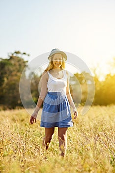 Thinking, smile and girl in countryside for vacation, holiday and travel in nature field outdoor in Germany. Dream