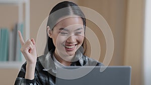 Thinking student girl asian pensive woman portrait sits in front of laptop doing online task looking for problem