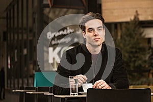 Thinking thoughtful young man cafe coffee cup outdoors