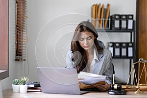 Thinking woman lawyers discussing contract papers with brass scale in office. Law, legal services, advice, Justice and