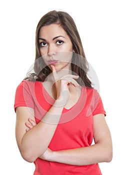 Thinking woman with long dark hair and red shirt