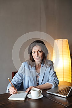 Thinking woman writer sitting indoors