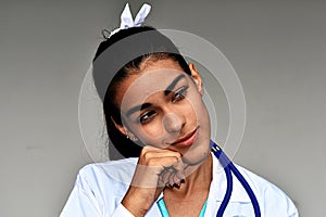 Thinking Young Hispanic Female Doctor