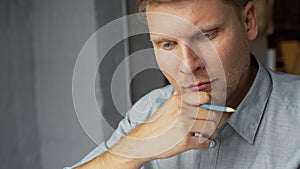 Thinking young man in the office