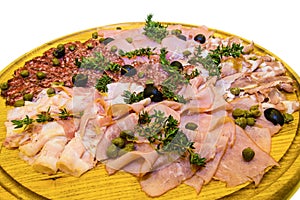 Thinly sliced ham and salami with greens.