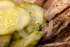 Thinly sliced homemade lard with pepper and chopped pickles close-up, selective focus