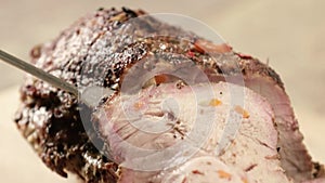 A thinly sliced piece of oven-baked meat. Demonstration of baked meat