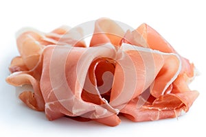 Thinly sliced Prosciutto ham. Isolated on white