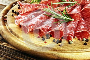 Thinly sliced salami, delicious snack rustic salami on table