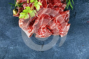 Thinly sliced salami, delicious snack rustic salami on table