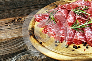 Thinly sliced salami, delicious snack rustic salami on table