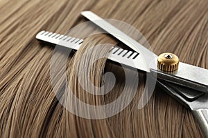 Thinning scissors on light brown hair. Hairdresser service