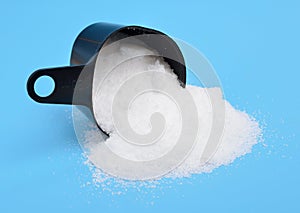 Thiourea powder on blue background.