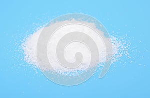 Thiourea powder on blue background.