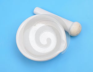 Thiourea powder on blue background.