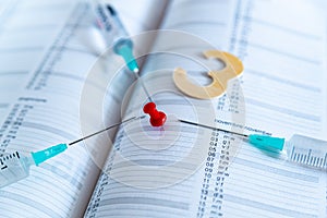 Third covid vaccine dose and jab concept. Three syringes are seen on calendar as a concept for the 3rd covid-19 vaccine dose, also