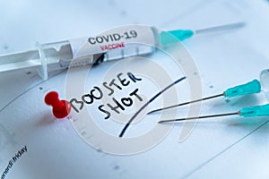 Third covid vaccine dose and jab concept. Three syringes are seen on calendar as a concept for the 3rd covid-19 vaccine dose, also