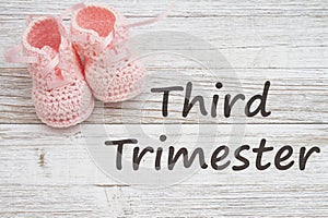 Third Trimester message with pink baby booties photo