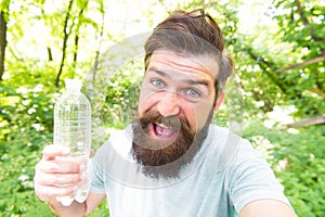 Thirst is everything. Thirsty man. Bearded man holding bottle of drinking water to quench his thirst. Thirst or