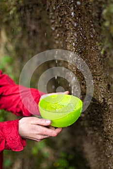 Thirst in mountains. Gathering water in nature