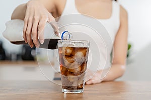 Thirsty, asian young woman, girl holding, pouring cold cola soft drink soda, sparkling water with ice sweet sugar from bottle