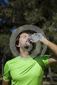 Thirsty athlete drinking water after workout