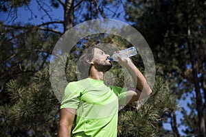Thirsty athlete drinking water after workout